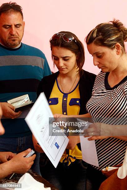 Iraqis living in Jordan capital Amman, wait in queue to cast their ballots in the Iraqi parliamentary elections at the polling station in Amman,...