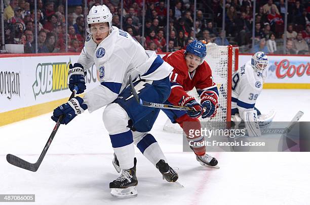 Keith Aulie of the Tampa Bay Lightning clears the puck against the Montreal Canadiens in Game Four of the First Round of the 2014 Stanley Cup...