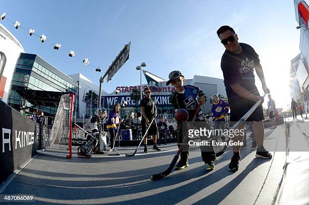 Fans play a game of street hockey before Game Four of the First Round of the 2014 Stanley Cup Playoffs between the Los Angeles Kings and the San Jose...