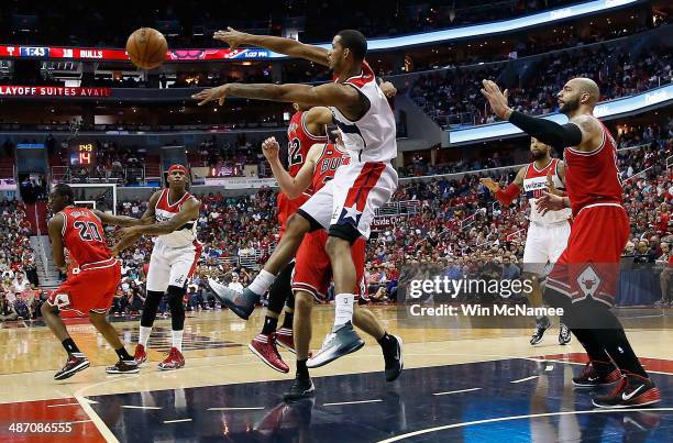 Trevor Ariza of the Washington Wizards pases the ball in the lane over Mike Dunleavy of the Chicago Bulls in Game Four of the Eastern Conference...