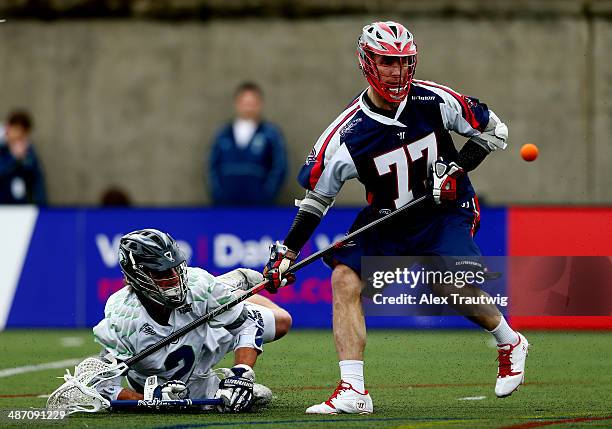 Kyle Sweeney of the Boston Cannons defends against Brendan Mundorf of the Chesapeake Bayhawks during a game at Harvard Stadium on April 27, 2014 in...