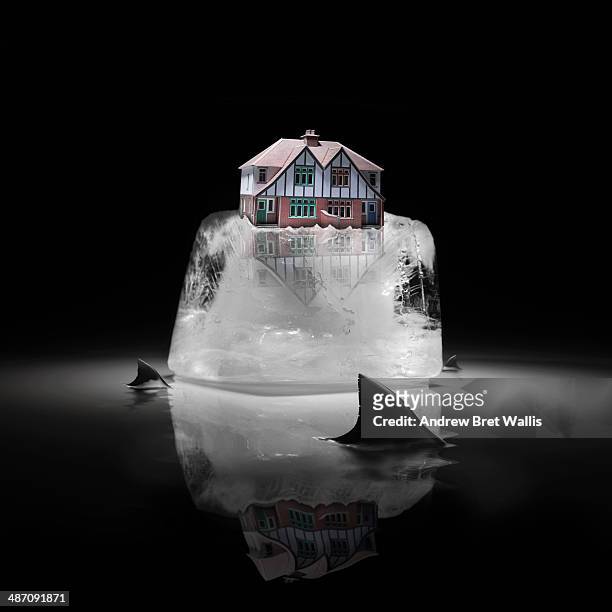 house on a meting iceberg surrounded by sharks - dorsal fin stock pictures, royalty-free photos & images