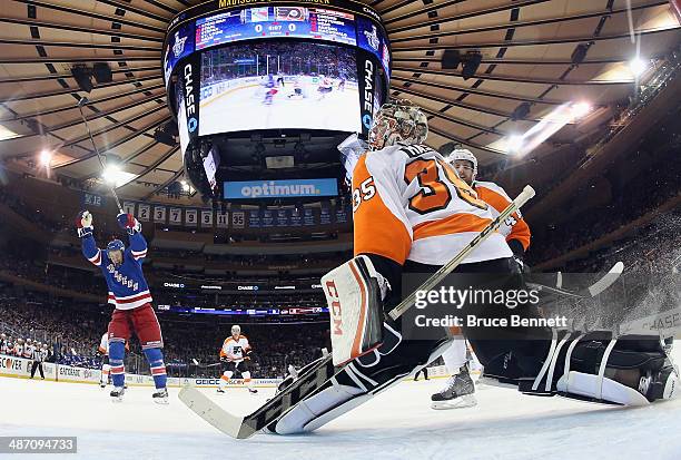 Derek Stepan of the New York Rangers celebrates a goal by Marc Staal against Steve Mason of the Philadelphia Flyers during the first period in Game...