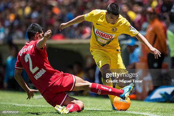 Francisco Gamboa of Toluca fights for the ball with Luis Mendoza of America during a match between Toluca and America as part of the 17th round...