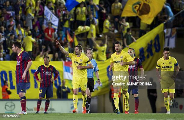 Villarreal's midfielder Cani celebrates after scoring during the Spanish league football match Villarreal CF vs FC Barcelona at El Madrigal stadium...