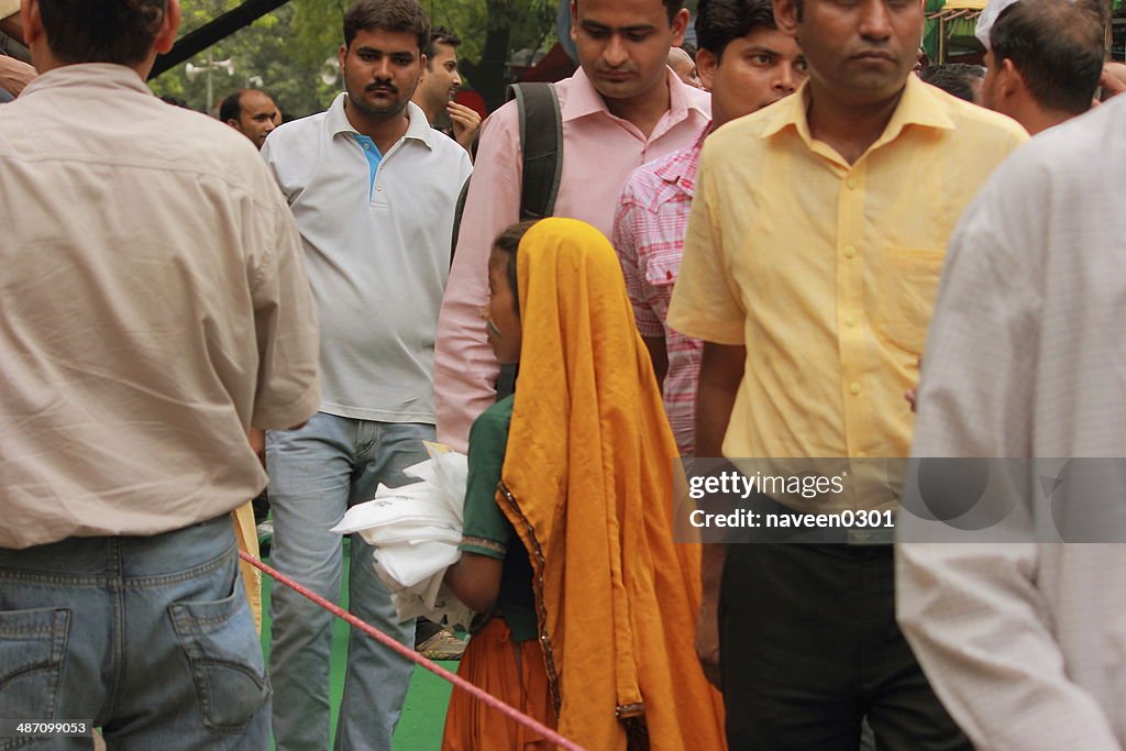 Littele girl selling cap at protest venue