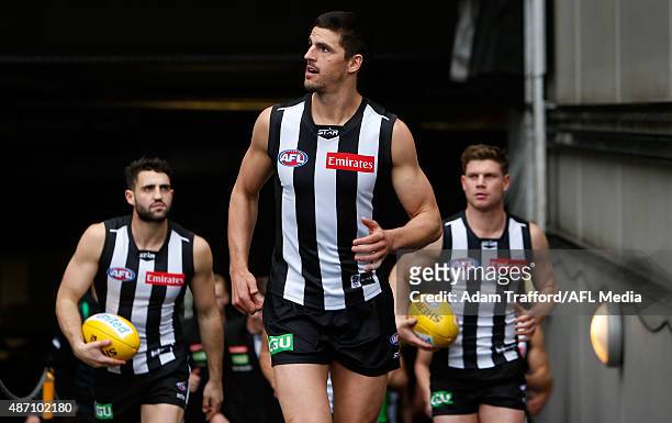 Scott Pendlebury of the Magpies leads the team up the race during the 2015 AFL round 23 match between the Collingwood Magpies and the Essendon...