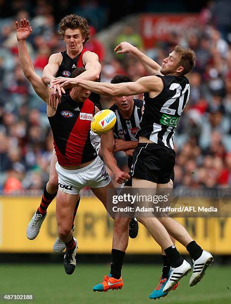 Joe Daniher and Kyle Langford of the Bombers compete for the ball with Brayden Maynard and Ben Reid of the Magpies during the 2015 AFL round 23 match...