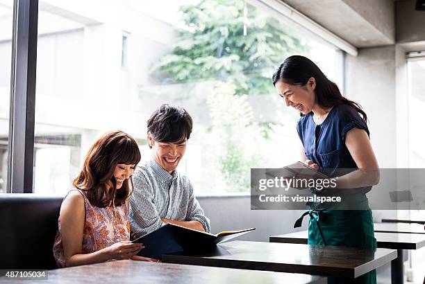 asian couple ordering food in cafeteria - customer satisfaction stock pictures, royalty-free photos & images