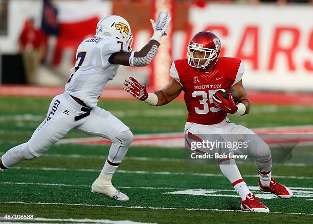 Kenneth Farrow of the Houston Cougars looks to avoid being tackled by Bill Dillard of the Tennessee Tech Golden Eagles on September 5, 2015 in...