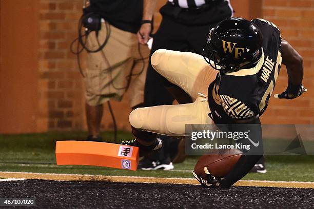 Chuck Wade of the Wake Forest Demon Deacons falls across the goal line for a 27-yard touchdown against the Elon Phoenix at BB&T Field on September 3,...