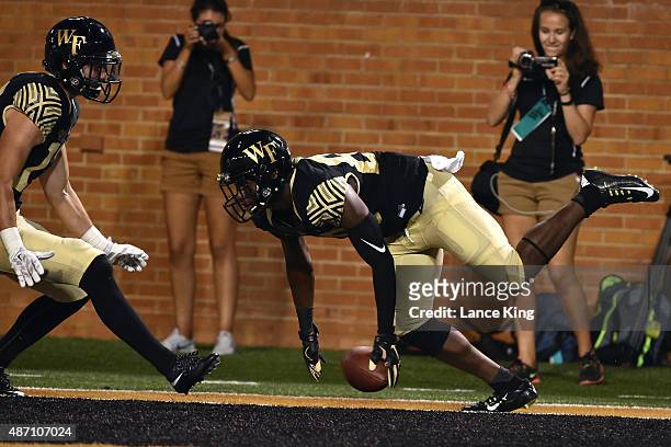 Chuck Wade of the Wake Forest Demon Deacons reacts after a 27-yard touchdown against the Elon Phoenix at BB&T Field on September 3, 2015 in...