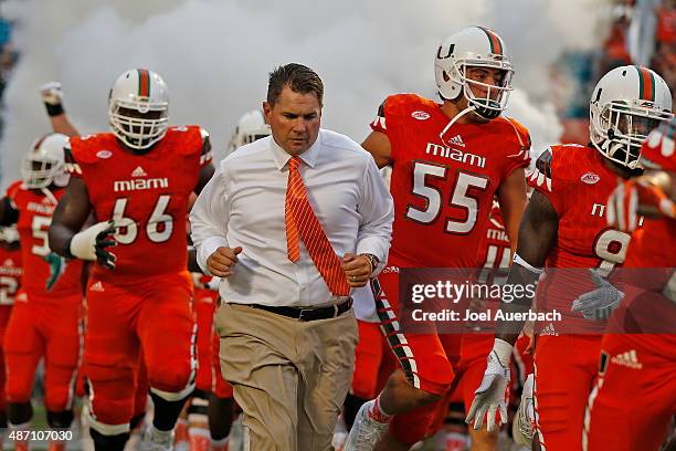 Head coach Al Golden of the Miami Hurricanes leads the players onto the field for their game against the Bethune-Cookman Wildcats on September 5,...