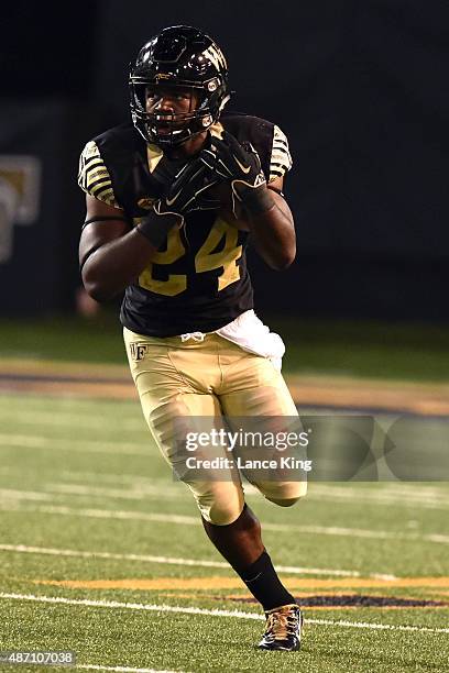 Tyler Bell of the Wake Forest Demon Deacons runs with the ball against the Elon Phoenix at BB&T Field on September 3, 2015 in Winston-Salem, North...