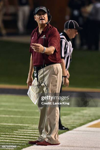 Defensive Coordinator Jerry Petercuskie of the Elon Phoenix signals a player during their game against the Wake Forest Demon Deacons at BB&T Field on...