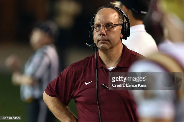 Head Coach Rich Skrosky of the Elon Phoenix looks toward the scoreboard during their game against the Wake Forest Demon Deacons at BB&T Field on...