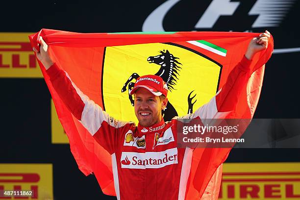 Sebastian Vettel of Germany and Ferrari celebrates on the podium after finishing second in the Formula One Grand Prix of Italy at Autodromo di Monza...