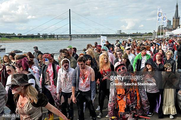 Participants take part at the Zombie Walk Duesseldorf along the Rheinuferpromenade on September 6, 2015 in Duesseldorf, Germany. A zombie walk is an...