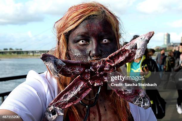 Participants take part at the Zombie Walk Duesseldorf along the Rheinuferpromenade on September 6, 2015 in Duesseldorf, Germany. A zombie walk is an...