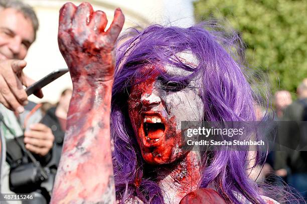 Participants take part at the Zombie Walk Duesseldorf along the Rheinuferpromenade on September 6, 2015 in Duesseldorf, Germany. A zombie walk is an...