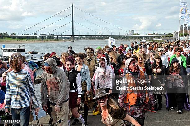 Participants take part at the Zombie Walk Duesseldorf along the Rheinuferpromenade on September 6, 2015 in Duesseldorf, Germany. A zombie walk is an...