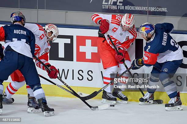 Keith Aucoin of Red Bull Muenchen, Markus Pock of KAC and Jeremy Dehner of Red Bull Muenchen fight for the puck during the Champions Hockey League...