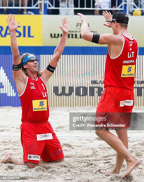 Aleksandrs Samoilovs and Janis Smedins of Latvia celebrate their victory after winning the gold medal match against Germany at Copacabana beach...