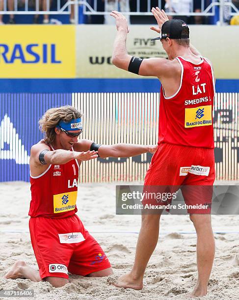 Aleksandrs Samoilovs and Janis Smedins of Latvia celebrate their victory after winning the gold medal match against Germany at Copacabana beach...