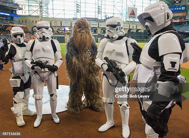 Chewbacca character along with the Stormtroopers take the field on Star Wars Day before the game between the Minnesota Twins and Houston Astros at...