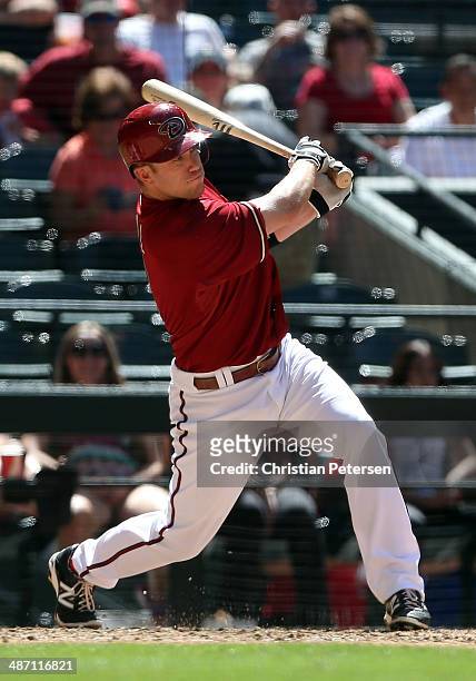 Aaron Hill of the Arizona Diamondbacks hits a single against the Philadelphia Phillies during the fourth inning of the MLB game at Chase Field on...