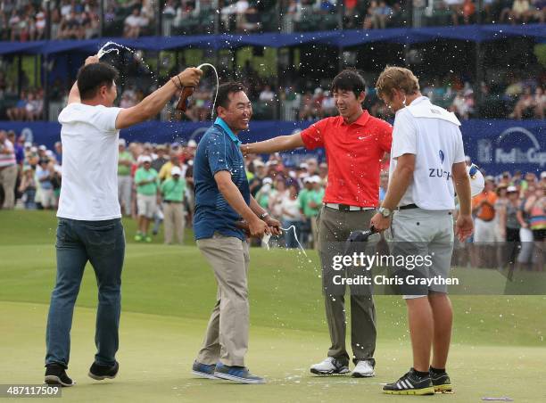 Seung-Yul Noh celebrates with golfers Charlie Wi and Y.E. Yang and his caddy Scott Saitinac after his win during the Final Round of the Zurich...