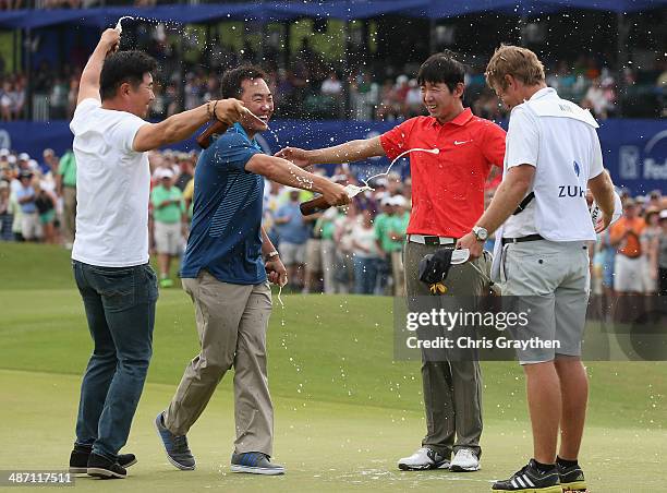 Seung-Yul Noh celebrates with golfers Charlie Wi and Y.E. Yang and his caddy Scott Saitinac after his win during the Final Round of the Zurich...