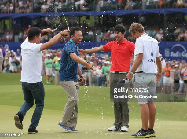 Seung-Yul Noh celebrates with golfers Charlie Wi and Y.E. Yang and his caddy Scott Saitinac after his win during the Final Round of the Zurich...