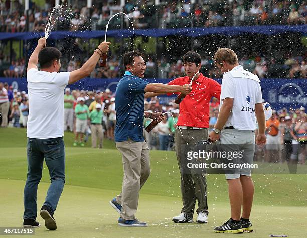 Seung-Yul Noh celebrates with golfers Charlie Wi and Y.E. Yang and his caddy Scott Saitinac after his win during the Final Round of the Zurich...