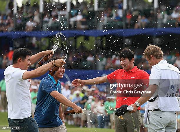 Seung-Yul Noh celebrates with golfers Charlie Wi and Y.E. Yang and his caddy Scott Saitinac after his win during the Final Round of the Zurich...