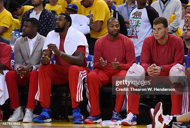 Los Angeles Clippers players sit on the bench wearing their warm-up tops inside out against the Golden State Warriors in Game Four of the Western...