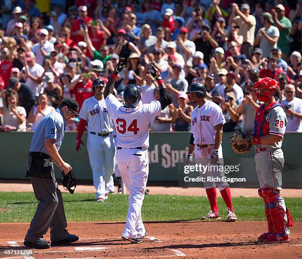 David Ortiz of the Boston Red Sox celebrates at home plate after he hit career home run during the first inning against the Philadelphia Phillies at...