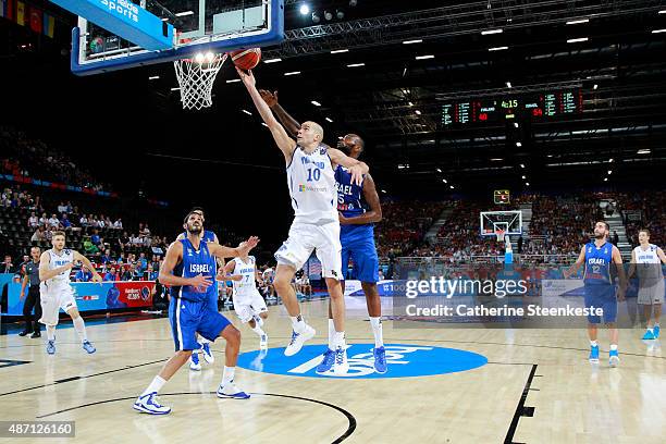 Tuukka Kotti of Finland is at the basket against D'or Fischer of Israel during the EuroBasket Group Phase game between Finland v Israel at Park and...