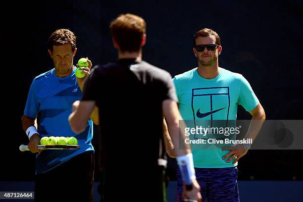 Coach Jonas Bjorkman and Captain of Great Britain Leon Smith look on as Andy Murray of Great Britain attends a practice session on Day Seven of the...