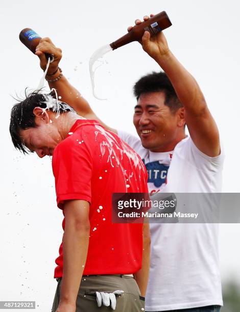 Seung-Yul Noh has beer poured on him by golfer Y.E. Yang after winning the Zurich classic during the final round of the Zurich Classic of New Orleans...