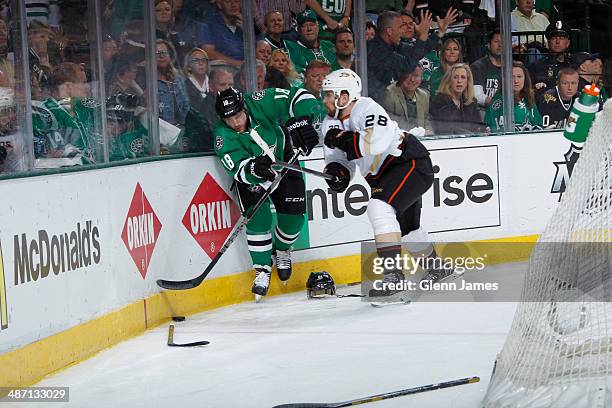 Chris Mueller of the Dallas Stars battles for possession of the puck among a scattering of broken sticks and helmets against Mark Fistric of the...