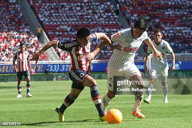 David Ramirez of Chivas fights for the ball with Ricardo Osorio of Monterrey during a match between Chivas and Monterrey as part of the 17th round of...