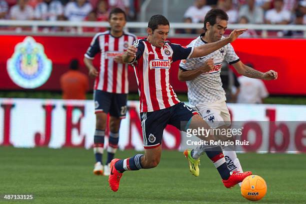 Israel Castro of Chivas fights for the ball with Cesar Delgado of Monterrey during a match between Chivas and Monterrey as part of the 17th round of...