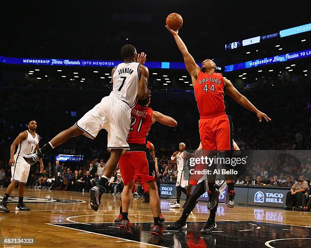 Joe Johnson of the Brooklyn Nets and Chuck Hayes of the Toronto Raptors go for a rebound in Game Four of the Eastern Conference Quarterfinals during...