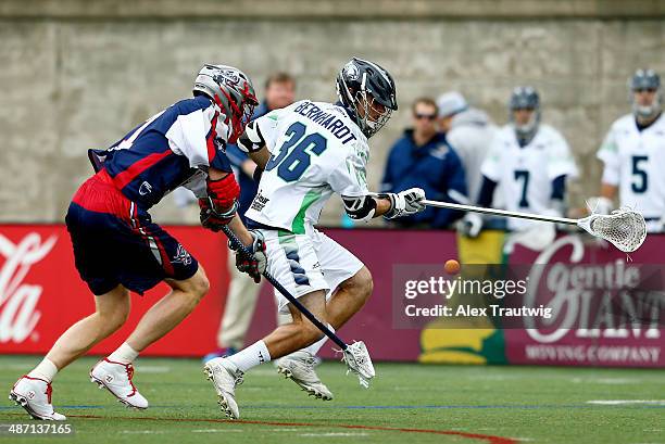 Jesse Bernhardt of the Chesapeake Bayhawks and Brodie Merrill of the Boston Cannons battle for a loose ball during a game at Harvard Stadium on April...