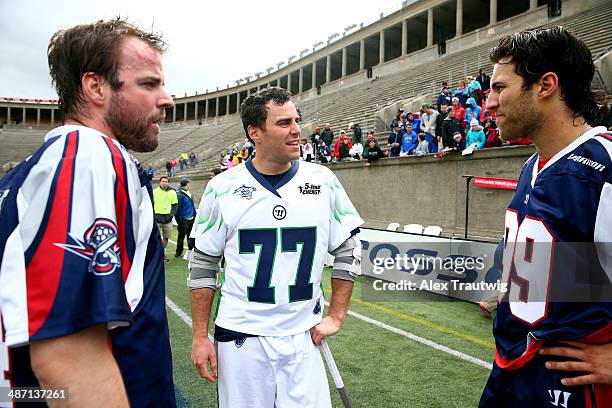 Stephen Peyser of the Chesapeake Bayhawks speaks with Ryan Boyle and Paul Rabil of the Boston Cannons after a game at Harvard Stadium on April 27,...