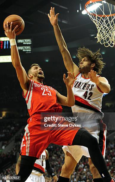 Chandler Parsons of the Houston Rockets drives to the basket against Robin Lopez of the Portland Trail Blazers in the first quarter of Game Four of...