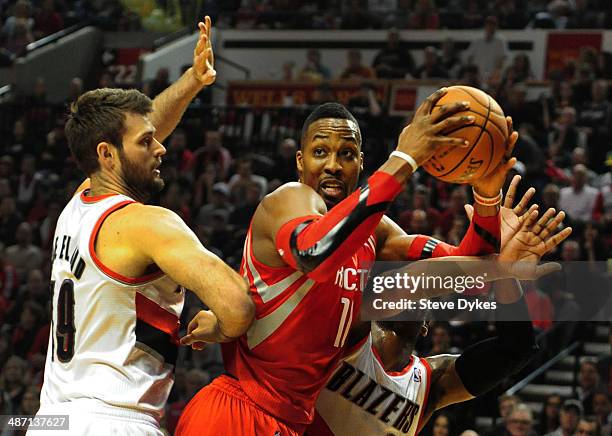 Dwight Howard of the Houston Rockets looks to pass the ball as Joel Freeland of the Portland Trail Blazers defends in the first quarter of Game Four...