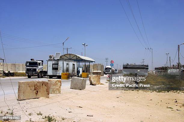 Trucks loaded with food supplies cross into the Palestinian city of Rafah through the Kerem Shalom crossing between Israel and the southern Gaza...