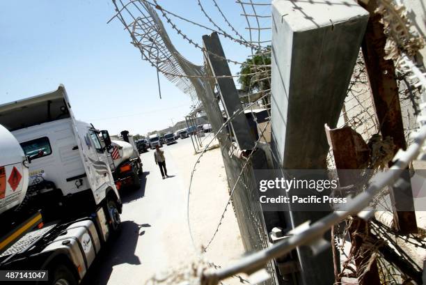 Trucks loaded with food and fuel supplies cross into the Palestinian city of Rafah through the Kerem Shalom crossing between Israel and the southern...